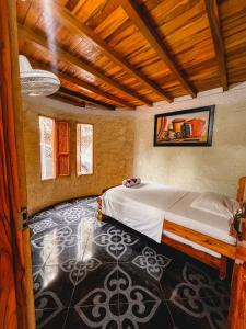 Postel nebo postele na pokoji v ubytování Hostal Vista Hermosa