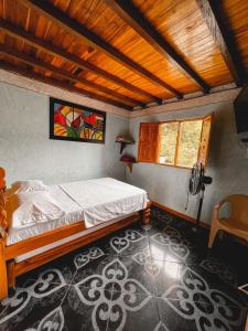 Postel nebo postele na pokoji v ubytování Hostal Vista Hermosa