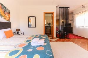 a bedroom with a large bed with pillows on it at Guincho Garden Villa by Homing in Aldeia de Juso