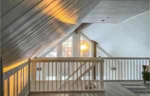 a wooden staircase in a house with a large window at Åreskutans Fjällstuga in Huså