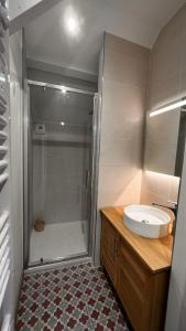 a bathroom with a sink and a shower at La Plonploniere in Aix-en-Issart