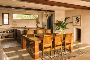 a dining room with a wooden table and chairs at Casa Sua in Famara