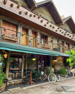 a building with two bikes parked outside of it at Hotel Giardino Di Pietra in Gramado