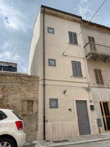 a white car parked in front of a building at #civico53 in San Benedetto del Tronto