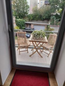 een patio met 2 stoelen en een tafel met een plant bij modernes 65qm Apartment im Herzen Schwerins in Schwerin