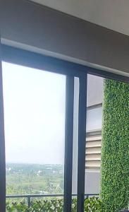 a window of a building with ivy on it at Lovely 1bedroom compact condo at 9th floor in Kelambākkam
