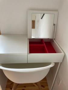 a white cabinet with a mirror in a room at TOYA LAKEHILL CABIN - The lake view cabin at Lake Toya in Lake Toya