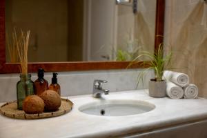 a bathroom counter with a sink and a mirror at Giannoulis - Grand Bay Beach Resort (Exclusive Adults Only) in Kolymvari +115 photos