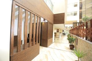 un corridoio di un edificio con pannelli e piante in legno di Cassiopeia Hotel ad Addis Abeba