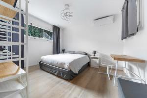 a bedroom with a bed and a desk and a ladder at Maison Giulia ai Giardini in Bologna