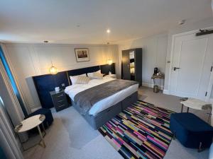 a bedroom with a large bed and a rug at Three Falcons in London