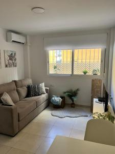 a living room with a couch and a window at Fuengirola Paseo Marítimo 27 in Fuengirola