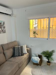 a living room with a couch and a window at Fuengirola Paseo Marítimo 27 in Fuengirola