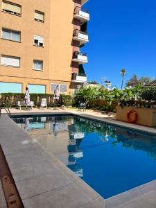 a swimming pool in front of a building at Fuengirola Paseo Marítimo 27 in Fuengirola
