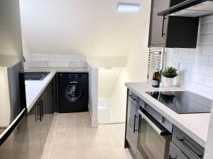 a kitchen with a washer and dryer in a room at 4 Fairfield Terrace, Pelaw in Gateshead