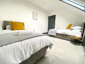 a bedroom with two beds and a window at 4 Fairfield Terrace, Pelaw in Gateshead