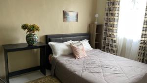 a bedroom with a bed with a vase on it at Little Cosy House at14 in Kuala Lumpur