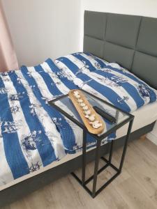 a shoe sitting on a bed with a blue and white comforter at Pokoje u Honi in Pobierowo