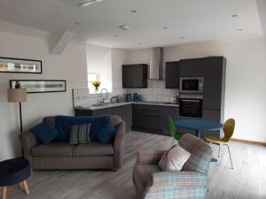a living room with a couch and a table at Ty Carreg Bach in Llanrwst +4 photos