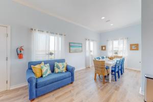 a living room with a blue couch and a table at Paradise Pointe in Port Aransas