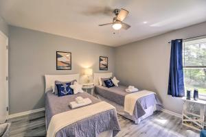 a bedroom with two beds and a ceiling fan at Swansboro Coastal Home Less Than 3 Mi to State Park! in Swansboro