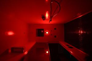 a red bathroom with a sink and red lights at CHIC HOUSE MATERA - Design e Parking a 200m dai Sassi in Matera