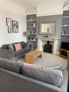 a living room with a couch and a fireplace at The Hole in the Wall, Midsomer Norton, Nr Bath & Longleat in Bath
