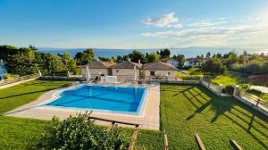 an aerial view of a house with a large swimming pool at Daphne Villas in Kriopigi
