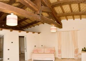 a living room with a couch and wooden ceilings at Hotel Soffio di Vento in Arbus