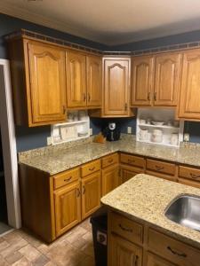 a kitchen with wooden cabinets and a sink at Southern Charm in Cadiz