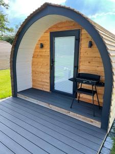 a gazebo with a picnic table in it at Eastridge Glamping - Camping Pods in Shrewsbury