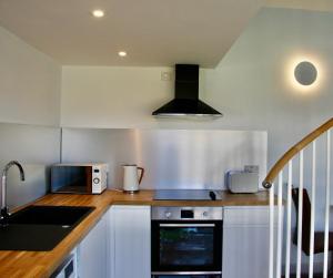 a kitchen with a sink and a stove top oven at Atlantic Drift - Isle of Skye - Amazing Sea views in Glendale