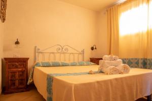 a bedroom with a bed with towels on it at Casa Gallo in Santa Marinella