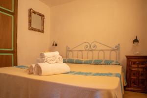 a bedroom with a bed with towels on it at Casa Gallo in Santa Marinella