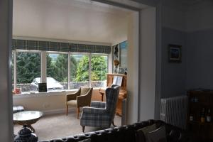 a living room with a couch and chairs and a window at Tigh Na Cloich in Pitlochry