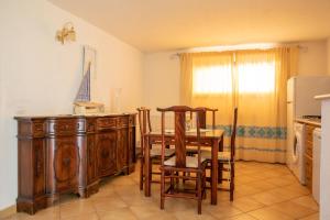 a kitchen with a table and chairs and a refrigerator at Casa Gallo in Santa Marinella