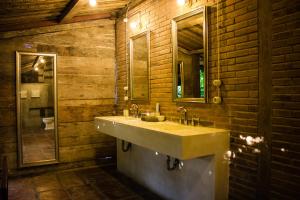 een badkamer met een wastafel en een spiegel bij Wahyu Private Lux Joglo Ideal For Couples W Pool in Seminyak