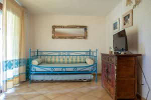 a blue bed in a room with a mirror and a dresser at Casa Gallo in Santa Marinella