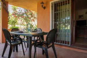 a table and chairs on a patio with a window at Casa Gallo in Santa Marinella