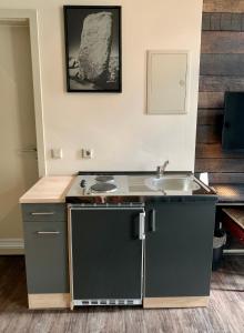 a small kitchen with a sink and a counter at Arbio I Apartmently Studios & Apartments in Berlin