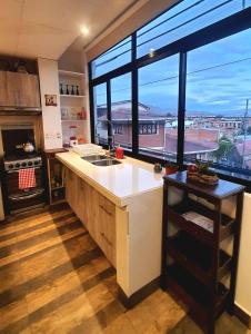 a kitchen with a sink and a large window at Studio Mirador, todo lo que necesitas para disfrutar in Tarija