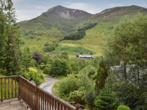 a balcony with a view of a mountain at Tamarchan Lodge in Ballachulish