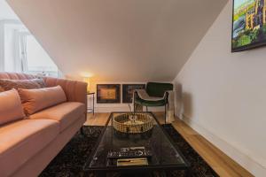 a living room with a couch and a table at The West End Loft - 5* Retreat - Private Parking! in Glasgow