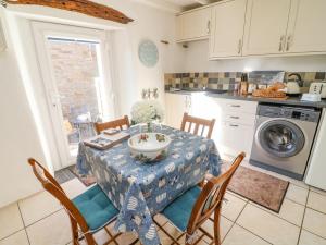 a kitchen with a table with a bowl on it at Moor Cottage in Carnforth