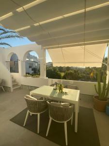 a white table and chairs on a patio at Penthouse with stunning views in Benahavís in Benahavís