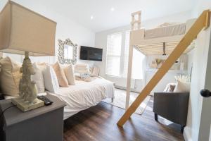 a bedroom with a bed and a loft bed at The Apartment - Brand new, stylish & central in Shanklin