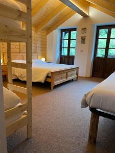 a bedroom with two bunk beds in a log cabin at Locanda Bocchetto Sessera in Bielmonte