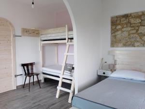 a bedroom with bunk beds and a desk and a chair at Minicasa nella fattoria in Atessa