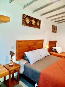 a bedroom with a bed and a nightstand and a bed sidx sidx sidx sidx at Casa Temporada Tiradentes in Tiradentes