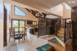 a dining room and kitchen with a table and chairs at Karinya Villas in Nainital